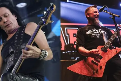 Dwóch członków Acid Drinkers na scenie: basista z długimi włosami i gitarzysta z brodą.