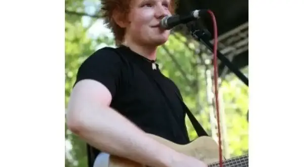 Ed Sheeran gra na gitarze, śpiewając do mikrofonu. Czy Ed Sheeran ma dzieci? Tak, jest ojcem dwójki.