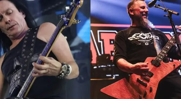 Dwóch członków Acid Drinkers na scenie: basista z długimi włosami i gitarzysta z brodą.