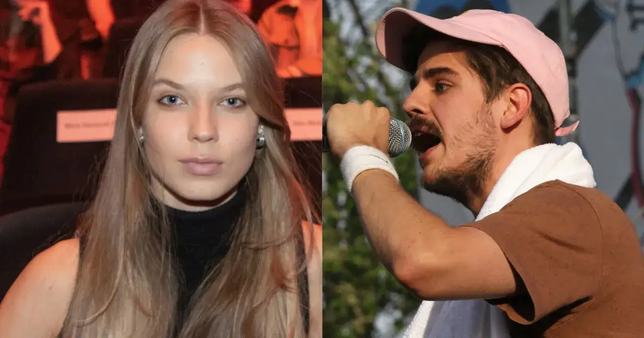 Taco Hemingway i jego partnerka, piękna blondynka, na tle sceny i zieleni.